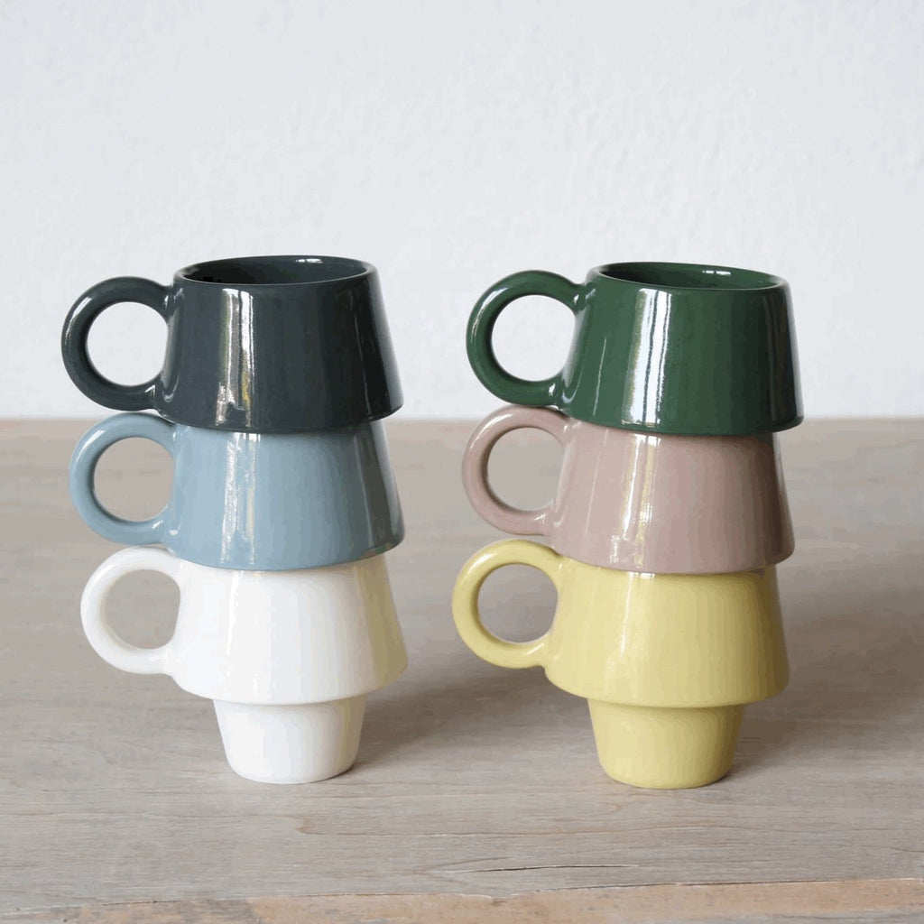 two stacks of handmade espresso cups in lots of different pastel colours. 