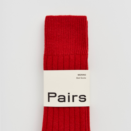 Red sock with 'Pairs' branding on a white background. Pairs Socks | Shop Fodder