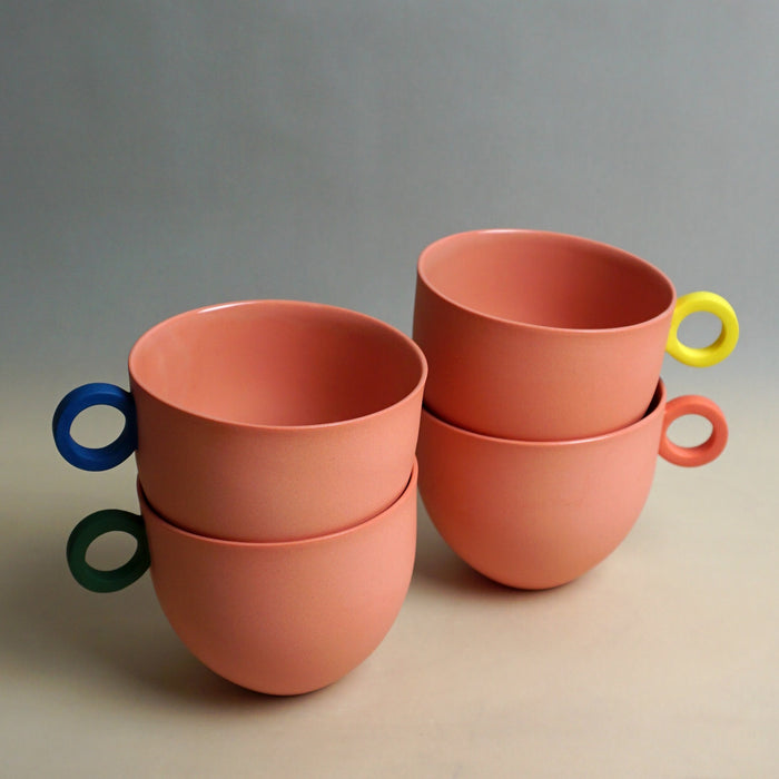Set of pink ceramic cups with colorful handles on a neutral background. Syros Mug | Anna Jones Ceramics | Shop Fodder