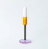 Coloured glass candlestick holder on white background