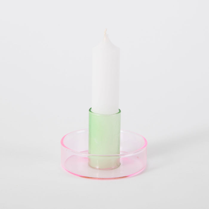 pink and green candlestick holder on white background. 