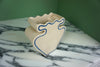 cream vase with blue outline pattern on a marble worktop