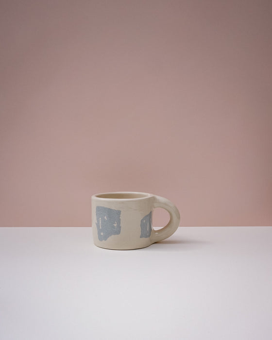 Ceramic mug with blue geometric design on a pink background. Portrait Mug | Brutes London | Handmade Ceramics | Fodder