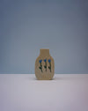 Small beige vase with blue floral design on a light gray background | Tulip Vase | Nerikomi | Fern Taylor | Shop Fodder