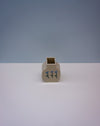 Small beige ceramic vase with blue floral design on a white surface and light gray background. | Tulip Vase | Nerikomi | Fern Taylor | Shop Fodder