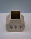 Ceramic vase with square base and rectangular top on a white surface with a light blue background. | Tulip Vase | Nerikomi | Fern Taylor | Shop Fodder