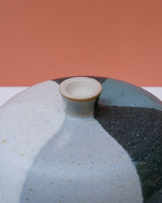 Ceramic vase with a textured surface on a peach background. Liz Vidal Ceramics | Shop Fodder