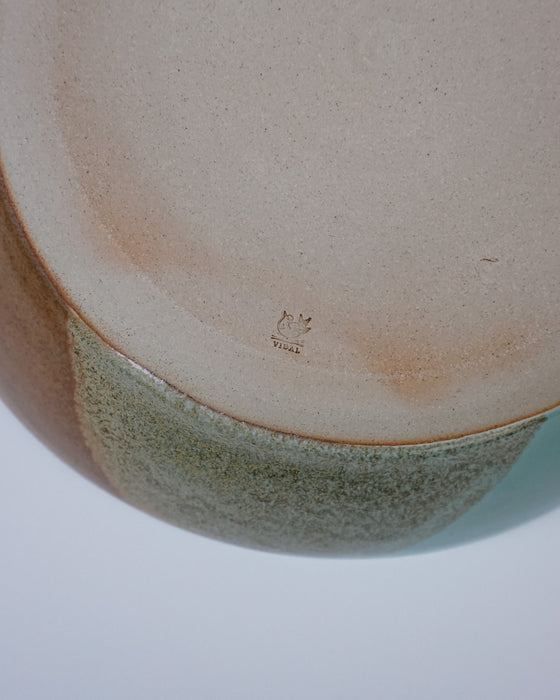 Close-up of a ceramic bowl with a speckled pattern on a white background. Liz Vidal Makers Mark. Fodder