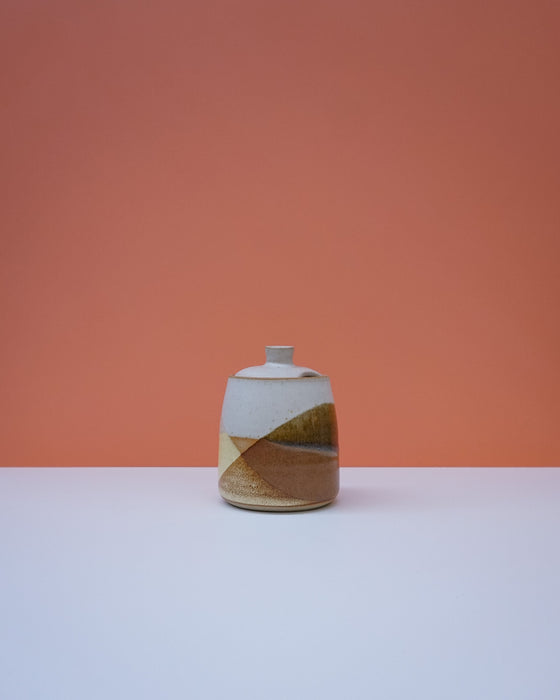 Ceramic vase with a geometric design on a peach background. Liz Vidal Ceramics | Shop Fodder