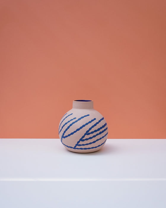 Vase with blue patterns on a peach and white background. Sophie Alda | Handmade Ceramics | Shop Fodder