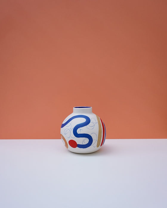 Decorative vase with colorful abstract design on a peach and white background. Sophie Alda | Handmade Ceramics | Shop Fodder
