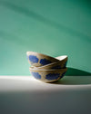 Two ceramic bowls with blue cloud patterns on a green and white background. Sophie Alda | Handmade Ceramics | Shop Fodder