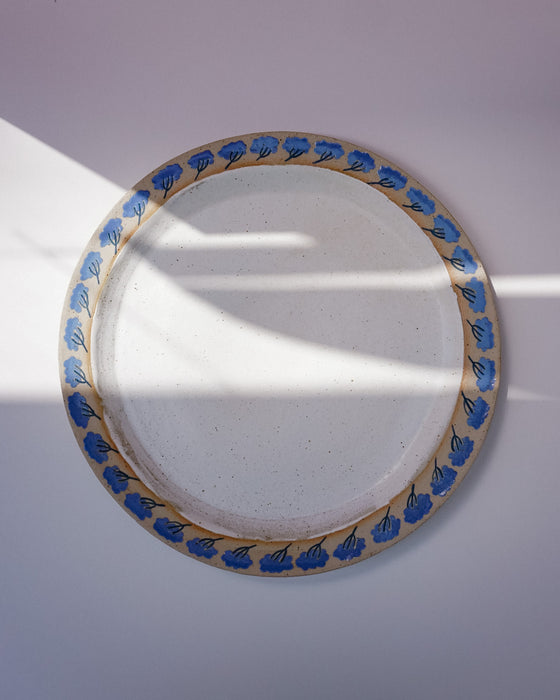 Round ceramic plate with blue floral patterns on a white background. Sophie Alda | Handmade Ceramics | Shop Fodder