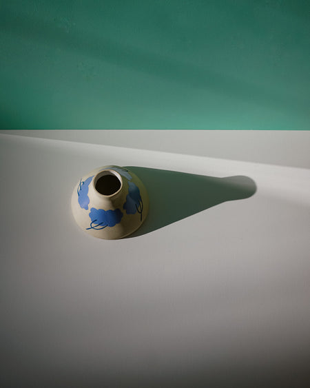 Ceramic vase with blue design on a white surface with teal background. Sophie Alda | Handmade Ceramics | Shop Fodder