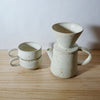 Mae Ceramics V60 with a coffee pot and two ridge cups all in Chalk. 