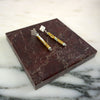 Pair of earrings on a marbled surface | Scarlett Cohen French | Shop Fodder