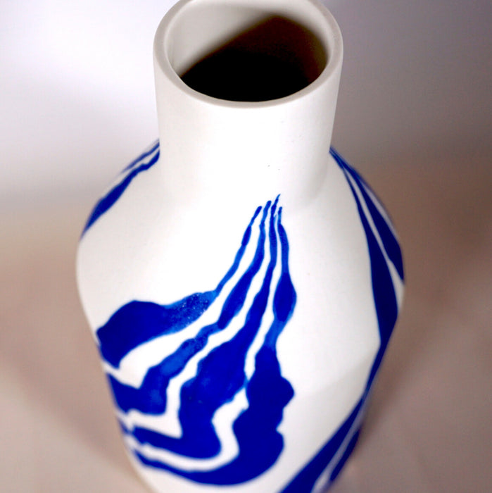 the neck of a porcelain white bottle vase with a bright blue leaf pattern. Sophie Alda | Handmade Ceramics | Shop Fodder