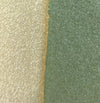 close up detail of sand clay and a sage green glaze. 