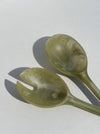 Two green ceramic spoons on a white background. Maegen | Shop Fodder